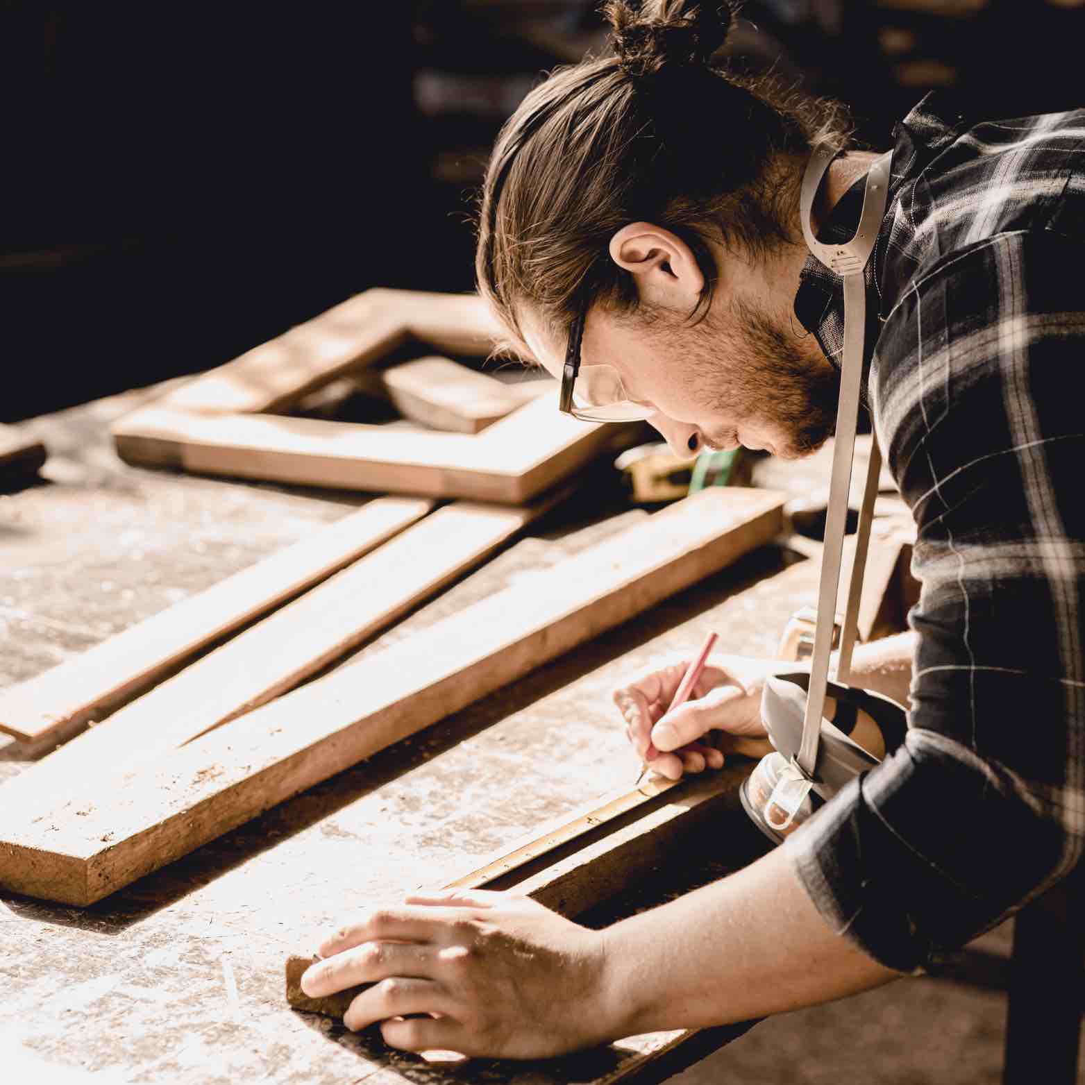 Person working on a wooden surface with tools